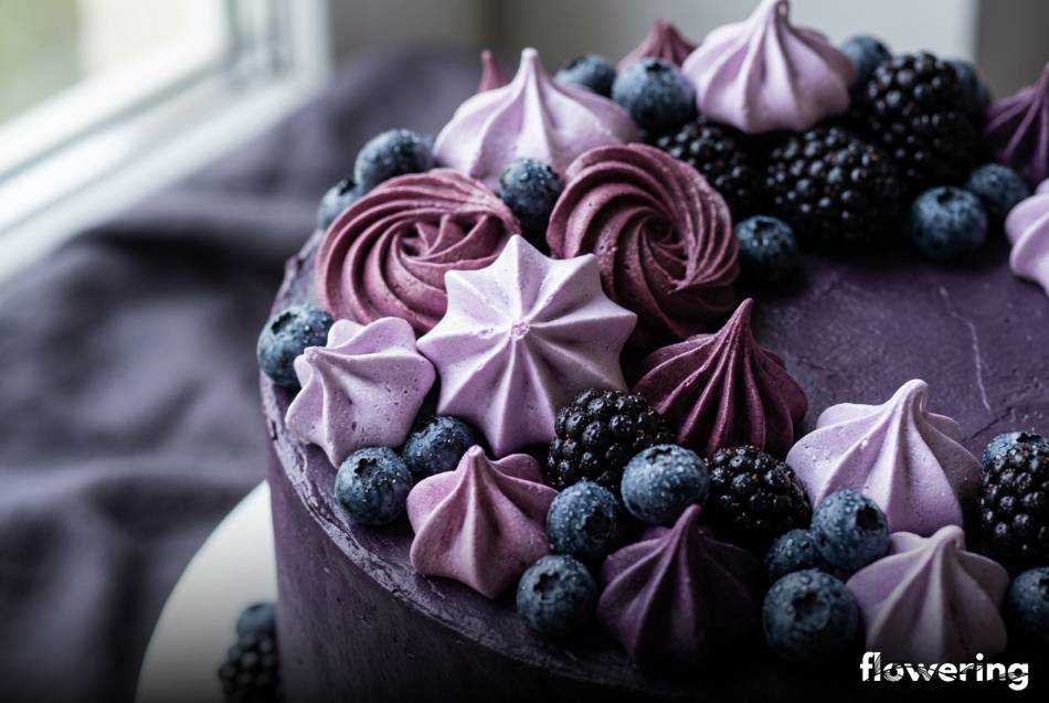 Monochromatyczne fioletowe beziki i świeże owoce jagodowe na torcie